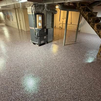 Finished basement with polished flooring and HVAC unit, showcasing modern design elements.