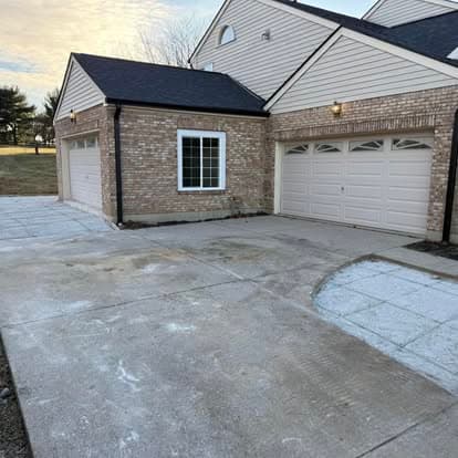 Modern garage with brick facade and driveway in residential setting.