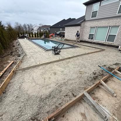 Concrete pool deck installation in progress, featuring a partially finished area around a pool.